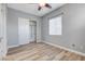 A bedroom with neutral walls, wood flooring, and access to a closet for maximum convenience at 4137 Cackling Goose Dr, North Las Vegas, NV 89084