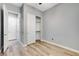 Bright bedroom featuring wood-look flooring, a closet, and a door leading to the hallway at 4137 Cackling Goose Dr, North Las Vegas, NV 89084
