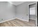 Bright bedroom featuring wood-look floors, neutral walls, and an adjacent room at 4137 Cackling Goose Dr, North Las Vegas, NV 89084