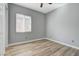 Cozy bedroom featuring natural light, wood-look floors, and neutral walls at 4137 Cackling Goose Dr, North Las Vegas, NV 89084