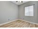 Bedroom with wood-look flooring, neutral walls, and window with adjustable blinds at 4137 Cackling Goose Dr, North Las Vegas, NV 89084
