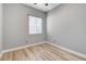 Bedroom featuring wood-look floors, neutral walls, and a window with adjustable blinds at 4137 Cackling Goose Dr, North Las Vegas, NV 89084