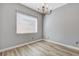 Bright dining room showcasing hardwood floors, wainscoting, chandelier, and ample natural light at 4137 Cackling Goose Dr, North Las Vegas, NV 89084
