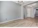Spacious dining room showcasing hardwood and tile floors, chandelier, and neutral paint at 4137 Cackling Goose Dr, North Las Vegas, NV 89084