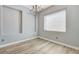 Bright dining room showcasing hardwood floors, wainscoting, chandelier, and ample natural light at 4137 Cackling Goose Dr, North Las Vegas, NV 89084