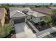 Up close aerial view of the home showing its garage and front entrance along with landscaping and part of the driveway at 4137 Cackling Goose Dr, North Las Vegas, NV 89084