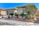 Single story home featuring a two car garage and desert landscaping at 4137 Cackling Goose Dr, North Las Vegas, NV 89084