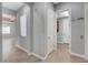 Hallway with neutral wall color leading to the living areas, showcasing the home's layout at 4137 Cackling Goose Dr, North Las Vegas, NV 89084