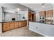 Kitchen featuring island, granite countertops, wood cabinets, and stainless steel appliances at 4137 Cackling Goose Dr, North Las Vegas, NV 89084
