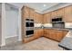 Kitchen with stainless steel double oven and wood cabinets at 4137 Cackling Goose Dr, North Las Vegas, NV 89084