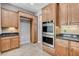 Kitchen area featuring stainless steel double ovens, granite counters, and plenty of cabinet space at 4137 Cackling Goose Dr, North Las Vegas, NV 89084
