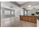 Open living room with windows, access to the backyard, and view to the kitchen bar at 4137 Cackling Goose Dr, North Las Vegas, NV 89084