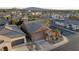 This aerial view shows a home with a tile roof and a desert landscape with a two car garage at 437 Via Stretto Ave, Henderson, NV 89011