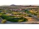 An aerial view captures the golf course, mountains, and community at 437 Via Stretto Ave, Henderson, NV 89011