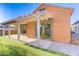 This exterior shows a covered back patio area with sliding glass doors and a cement porch at 437 Via Stretto Ave, Henderson, NV 89011