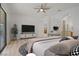 Modern bedroom with a king-sized bed, stylish decor, and backyard access at 437 Via Stretto Ave, Henderson, NV 89011