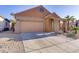 Exterior elevation featuring a two-car garage, a front porch, and desert landscaping at 437 Via Stretto Ave, Henderson, NV 89011
