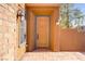 Charming front door with sidelight in a stucco home with a stone base at 437 Via Stretto Ave, Henderson, NV 89011
