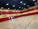 Spacious gymnasium with basketball hoops and striped red and white walls at 437 Via Stretto Ave, Henderson, NV 89011