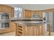 Spacious kitchen featuring custom cabinets, a large center island, and stainless steel appliances at 437 Via Stretto Ave, Henderson, NV 89011