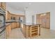 Bright, open kitchen featuring custom cabinetry, stainless steel appliances, and a large center island at 437 Via Stretto Ave, Henderson, NV 89011