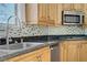 Kitchen featuring natural cabinets, granite countertops, and stainless steel appliances at 437 Via Stretto Ave, Henderson, NV 89011