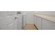 Functional laundry room includes modern washer and dryer, complemented by ample storage cabinets at 437 Via Stretto Ave, Henderson, NV 89011