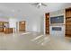 Open-concept living room with a built-in entertainment center and tile floors at 437 Via Stretto Ave, Henderson, NV 89011