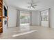 Open living room with a sliding glass door and entertainment center at 437 Via Stretto Ave, Henderson, NV 89011