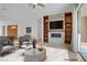 Inviting living room featuring a modern entertainment center, stylish seating, and natural light at 437 Via Stretto Ave, Henderson, NV 89011