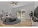 Virtual staging shows a stylish bedroom with backyard view and modern decor at 437 Via Stretto Ave, Henderson, NV 89011