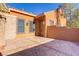 Large outdoor patio area surrounded by stucco walls and a lush tree at 437 Via Stretto Ave, Henderson, NV 89011