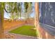 This side yard features an artificial turf area and a block wall with foliage along the wall at 437 Via Stretto Ave, Henderson, NV 89011