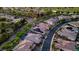 Overhead view of homes with solar panels, showcasing the neighborhood's lush landscaping and orderly street layout at 47 Garibaldi Way, Henderson, NV 89011