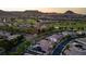 Expansive aerial shot of a residential area featuring well-maintained homes, golf courses, and scenic views at 47 Garibaldi Way, Henderson, NV 89011