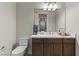Bathroom with a modern vanity with brown cabinets, sink, and white countertops at 47 Garibaldi Way, Henderson, NV 89011
