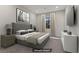 Comfortable staged bedroom featuring soft carpeting, neutral color palette, and ample natural light at 47 Garibaldi Way, Henderson, NV 89011