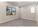 Bright, empty bedroom with large window and neutral carpet, ready for personalization at 47 Garibaldi Way, Henderson, NV 89011