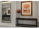 Elegant entryway featuring a console table, decorative mirror, and artwork at 47 Garibaldi Way, Henderson, NV 89011