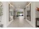 Inviting hallway with large decorative mirrors and views into the adjacent living area at 47 Garibaldi Way, Henderson, NV 89011