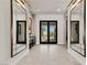 Bright entryway with stylish mirrors and a glimpse of the beautifully landscaped front yard at 47 Garibaldi Way, Henderson, NV 89011