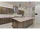 Gourmet kitchen features stainless steel appliances, custom cabinets, stylish lighting, and marble countertops at 47 Garibaldi Way, Henderson, NV 89011
