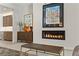 Living room with a sleek fireplace and a unique fish art piece at 47 Garibaldi Way, Henderson, NV 89011