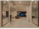Open living area with neutral tones, tile flooring and elegant mirrored wall decor at 47 Garibaldi Way, Henderson, NV 89011