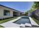 Backyard pool with tiled water feature and well-manicured landscape at 47 Garibaldi Way, Henderson, NV 89011