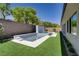 Backyard features a pristine pool, lush lawn, and privacy fence at 47 Garibaldi Way, Henderson, NV 89011