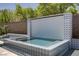 Beautiful pool with elegant tile design and modern waterfall feature at 47 Garibaldi Way, Henderson, NV 89011