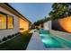 Gorgeous backyard with a modern pool, lush landscaping, and an inviting outdoor space at 47 Garibaldi Way, Henderson, NV 89011
