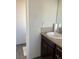 A bathroom with a dark wood cabinet, granite countertop, and a clean white sink at 4704 Obannon Dr # D, Las Vegas, NV 89102