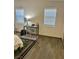 Bedroom with a sunny workspace, including an office chair and wood look flooring at 4704 Obannon Dr # D, Las Vegas, NV 89102